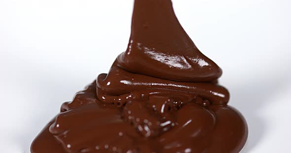 Chocolate Flowing on White Background, Slow Motion 4K alt