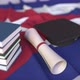 Graduation Cap Books and Diploma on the Cuban Flag