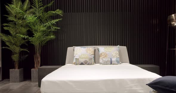 Modern bedroom interior with furniture with double bed and pillows. alt