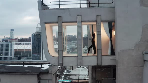 Choregraphy And Dance At The Glass Roof Balcony With A City Skyline