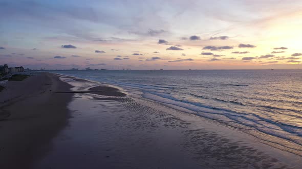 Aerial view of a sunset over the beach along the coast in Knokke, Belgium. alt