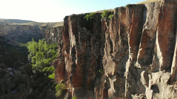 Aerial Deep Long Rift Canyon with Cleft Steep Rock Walls and High Cliff Gorge alt