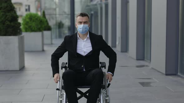 Crop View of Disabled Ceo Executive Wearing Medical Protective Mask and Looking To Camera alt