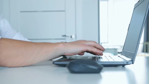 Financial Auditor Hands Pressing Keys Of Laptop