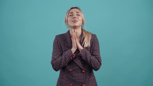 The Beautiful Young Woman Looks Up with Her Hands Clasped to Her Chest and Prays That Her Wish Will alt