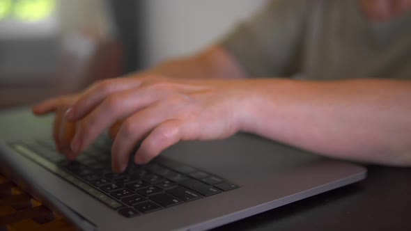 A Programmer is Writing Program Code on the Laptop