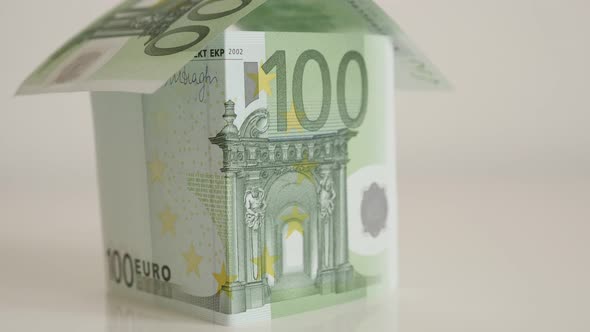Tilting on hundred Euro banknotes house concept 4K 2160p 30fps UHD footage - Slow tilt real estate m alt