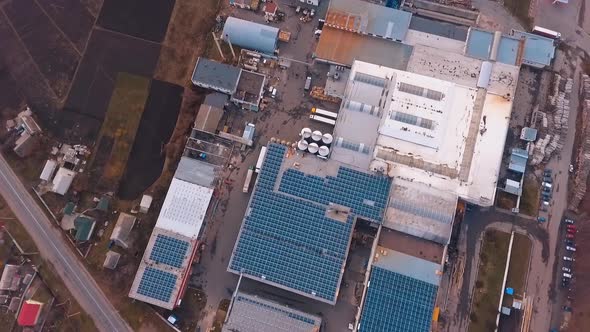 Plant or faсtory with solar panels on the roof, Electricity from sun energy alt