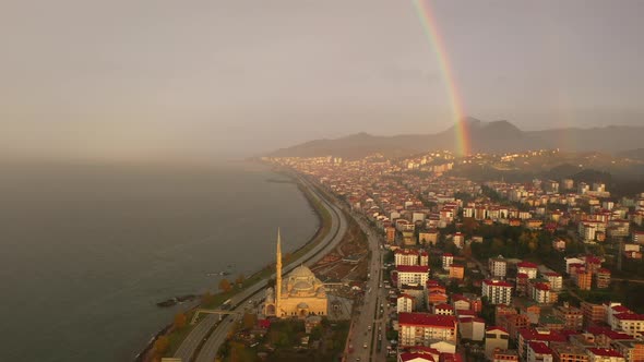Rainbow over city after rai