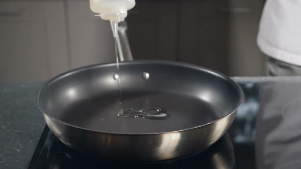 Pouring Oil Into Frying Pan Slow Motion alt