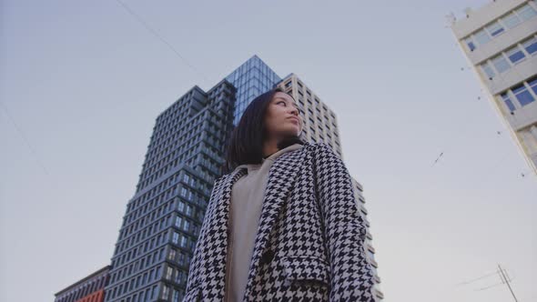 Lowangle Portrait of a Young Adult Asian Woman in Downtown District alt