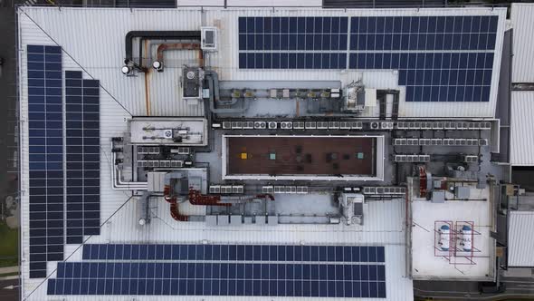 Top down aerial shot of solar panels on the roof of a building in San Jose alt
