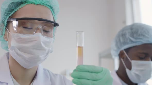 Two Scientists Working Together in Laboratory alt