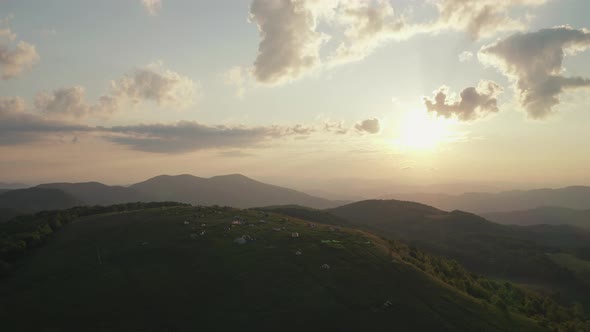 Aerial parallax of campers on top of mountain watching sunrise in Appalachians alt