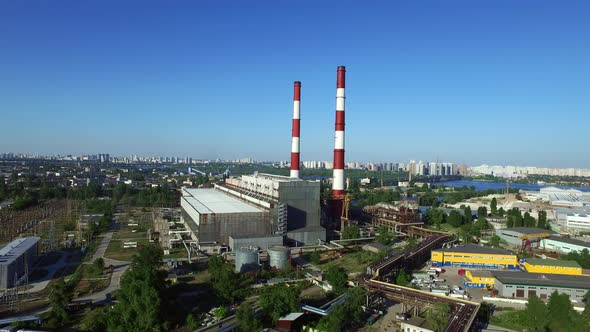 Chimneys on Power Plant on Modern City Landscape. Drone View Industrial Pipe alt