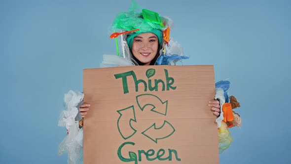 Woman holding cardboard with inscription save your planet on it.