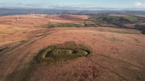 AERIAL: Close circle of historic castle ruins with autumn colours ...