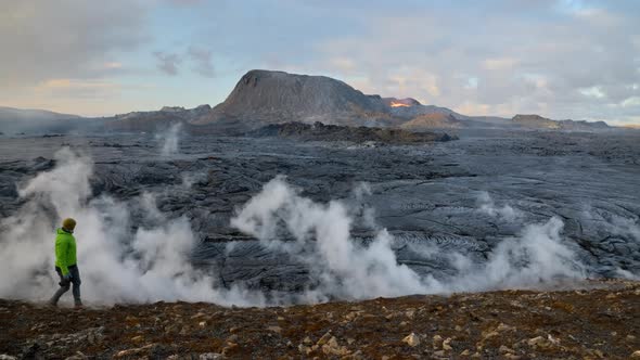 Photographer Walking Alongside Lava Flow From Erupting Fagradalsfjall Volcano alt