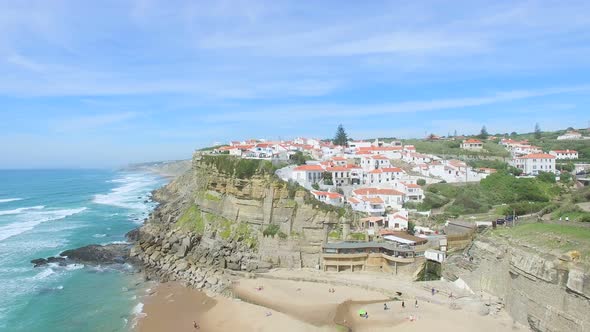 Aerial view of beach and cliffs next to Azenhas do Mar Village. alt
