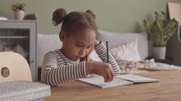 Bored Girl Scribbling in Copybook alt