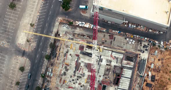 Flight over constructions site development, heavy machinery and construction workers are working