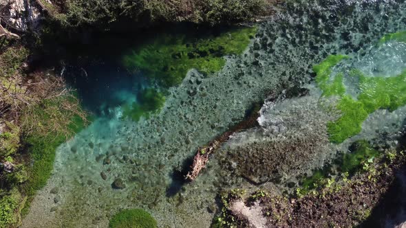Aerial drone view of a beautiful natural spring on a sunny day