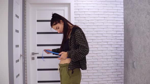 Sad Overweight Woman Measuring Her Waist with Loosing Weight Dieting