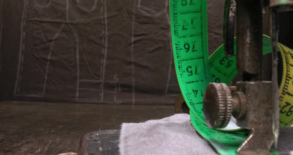 Antique tailor's workshop with threads on spools and tape measure. alt