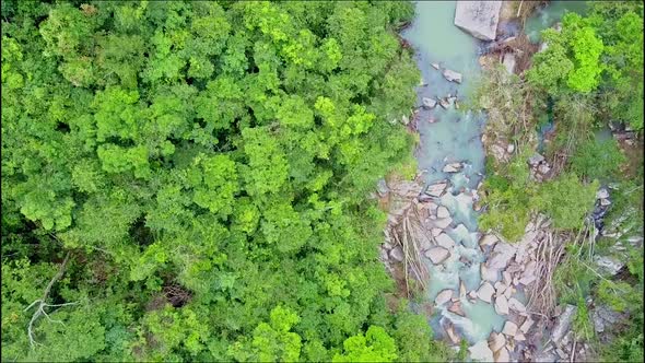 Aerial View Close Motion Along Jungle and Rocky River alt