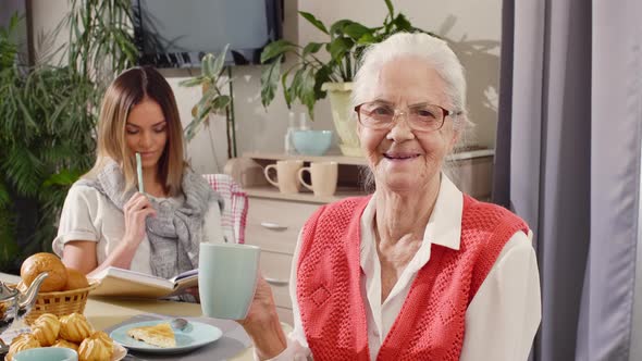 Portrait of Happy Grandmother Having Tea at Home