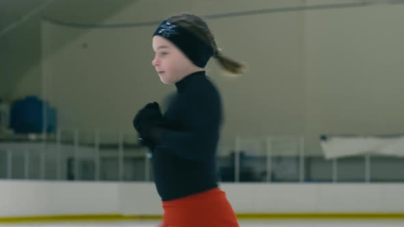 Young figure skater whirling around herself