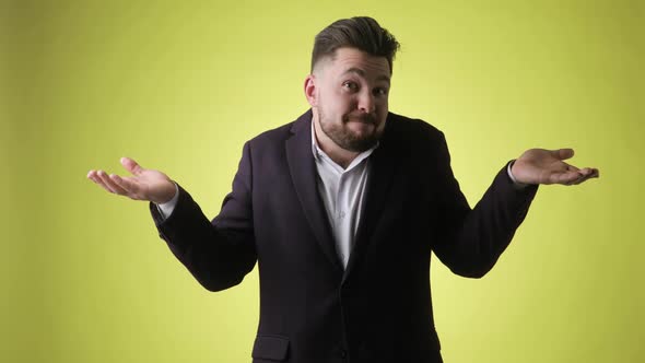 Confused Smiling Bearded Man in Office Suit Gestures i Don't Know Have No Idea alt