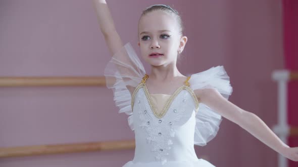 Ballet Training a Little Girl in White Dress Spinning on the Spot ...