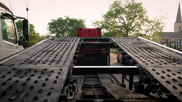 Trucks with a Car Hauler Stand in the Parking Lot alt