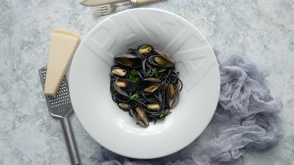 Black Seafood Spaghetti Pasta with Mussels Over Stone Background alt
