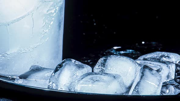 Ice Melts and Rotates on a Black Background. Timelapse alt