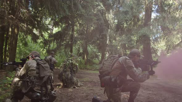 Reconnaissance Squad Covering Injured Soldier Waiting for Evacuation alt