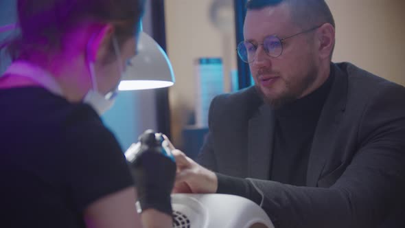 Male Manicure  Business Man Sitting Manicure Session Salon Talking Master alt