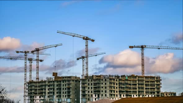 Construction Timelapse. Cranes Working On Residential Building Construction. Clouds And Blue Sky. 