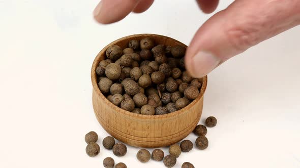Chef Taking Dry Allspice Peas From Wooden Spice Jar for Preparation Savory Tasty Food alt