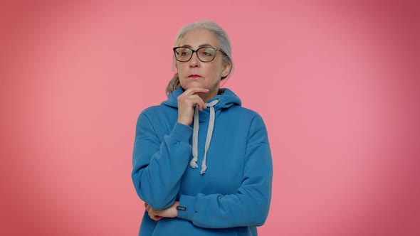 Thoughtful Clever Senior Old Grandma Woman Rubbing Her Chin Pondering a Solution Doubting Question alt