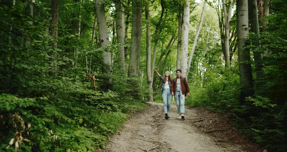 Couple of Tourists Walking in Forest