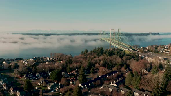 Fog rolls into and under the Tacoma Narrows Bridge in Puget Sound 4K UHD