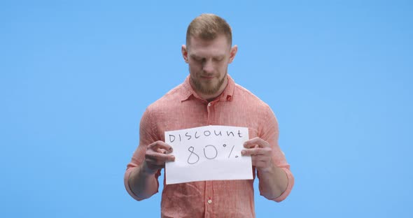 Young Man Holding Discount Sign alt