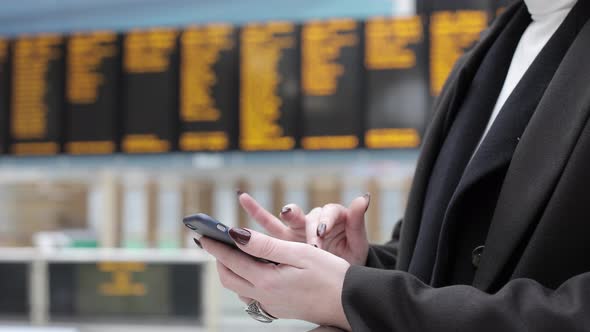 Young woman using smartphone at station