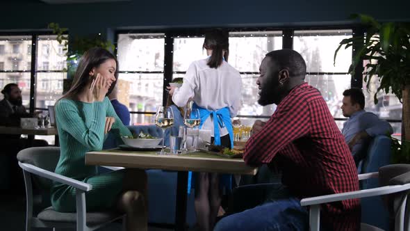 Couple Spending Time Dinning in Popular Restaurant alt