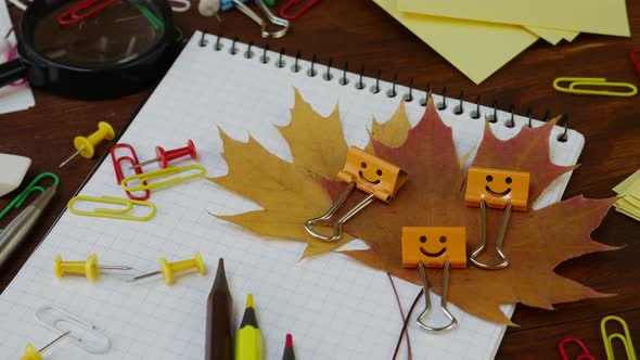 Smiles Yellow Binder Clip with Fallen Maple Leaves