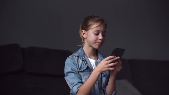 Teenager girl using smartphone at home
