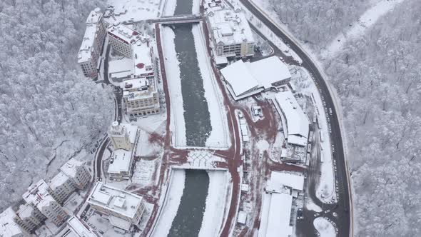 Aerial Top View Winter City Ski Resort Surrounded By Alpine Mountain Scenery alt