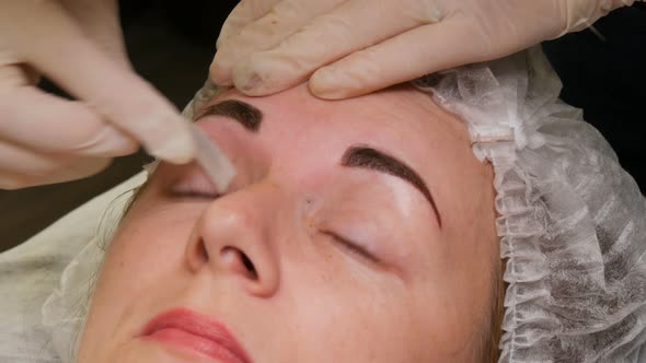 Correction of a Beautiful Aesthetic Shape of Eyebrows with Hot Wax and Special Tweezers